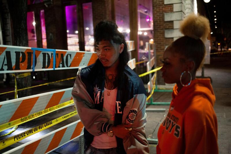 Coocheecoo De La Cruz and Sarai Goodson, of Killeen, Texas, watch as Police investigate the scene of a mass shooting in the Sixth Street entertainment district area of Austin, Texas, U.S.  Reuters