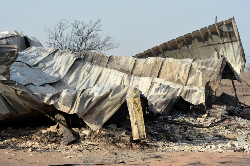 The remnants of a house north of Woodward, Okla., are seen Friday, April 13, 2018, after it was burned in a wildfire Thursday evening. A wildfire in northwestern Oklahoma has burned more than 120,000 acres and forced hundreds of people to evacuate their homes. (Johnny McMahan /The Woodward News via AP)