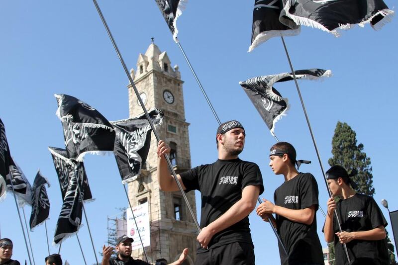 Supporters of the Hizb Ut-Tahrir party  in Tripoli, northern Lebanon, carry their party’s flags and chant during a rally in support of Palestinians, against Russian and the US. Omar Ibrahim / Reuters