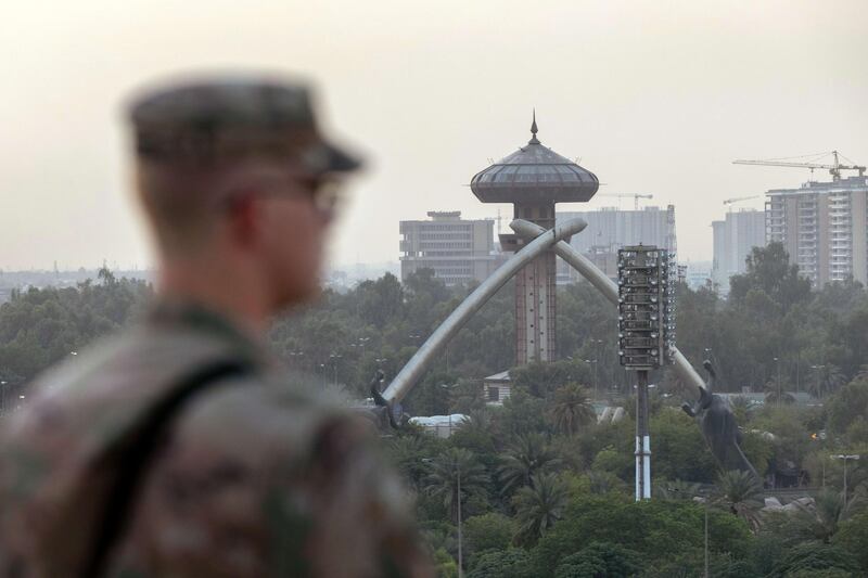 BAGHDAD, IRAQ - MAY 30: A U.S. Army soldier looks onto Baghdad and the Saddam-era Crossed Sabers monument from the International Zone on May 30, 2021 in Baghdad, Iraq. Coalition forces based in Baghdad's International Zone are part of the U.S.-led Military Advisor Group of 13 nations supporting the Iraqi Security Forces. The United States currently maintains 2,500 military personnel in Iraq as part of Operation Inherent Resolve. Alpha Company 769th brigade Engineer Battalion, Louisiana National Guard is providing force protection at the base.   John Moore/Getty Images/AFP
== FOR NEWSPAPERS, INTERNET, TELCOS & TELEVISION USE ONLY ==
