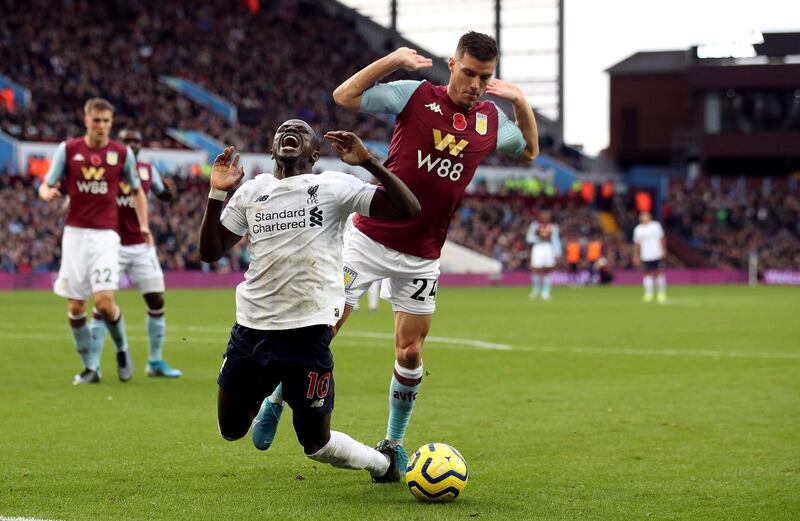 Liverpool's Sadio Mane goes down in the area under the challenge from Aston Villa's Frederic Guilbert and is booked for diving during the Premier League match at Villa Park, Birmingham. PA Photo. Picture date: Saturday November 2, 2019, See PA story SOCCER Villa. Photo credit should read: Nick Potts/PA Wire. RESTRICTIONS: EDITORIAL USE ONLY No use with unauthorised audio, video, data, fixture lists, club/league logos or "live" services. Online in-match use limited to 120 images, no video emulation. No use in betting, games or single club/league/player publications.