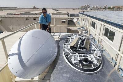 DUBAI, UNITED ARAB EMIRATES. 26 October 2017.  Yahsat satellite headquarters. The company is testing a 50Mbps connection for use onboard with Ethad flights. It means airlines will be able to offer a connection onboard that will be strong enough to stream HD content, browse the internet at superfast speed and seamlessly use messaging apps. The technology being tested is to be installed on aircraft. aulo Reyes, Systems Technician at Yahsat, looks at the antennae array on the roof of the container housing the testing infrastructure. The white cover on the left of the frame is the cover that normally encloses the array. It was removed for the media. (Photo: Antonie Robertson/The National) Journalist: Ramola Talwar. Section: National.