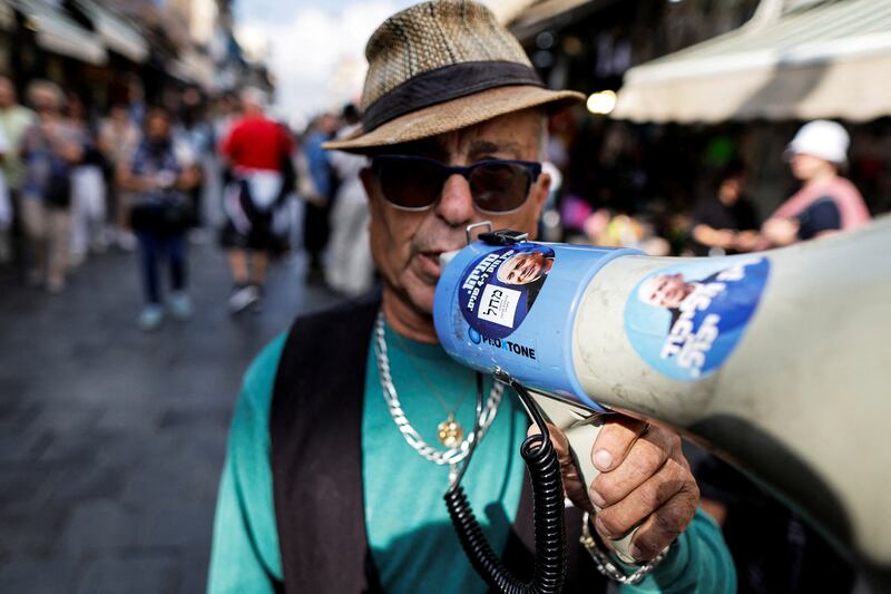 A supporter of former Israeli prime minister Benjamin Netanyahu's Likud party on the campaign trail at Mahane Yehuda market in Jerusalem on polling day's eve. Reuters