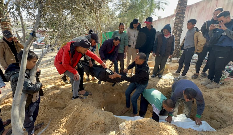 People bury Palestinians killed in an Israeli air strike at Al Nasser Hospital in Khan Younis, southern Gaza. Reuters