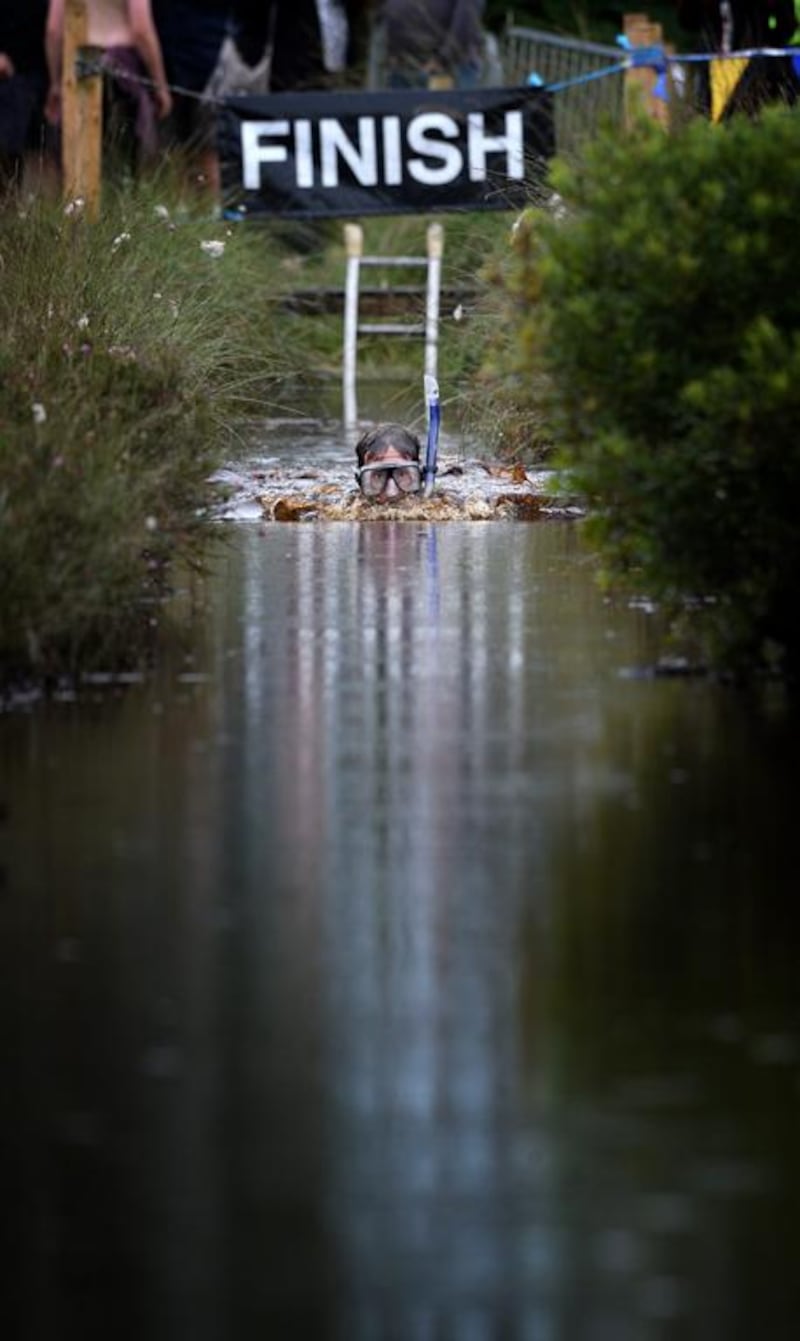 A male entrant takes part in the Irish Bog Snorkelling championship on Sunday. Charles McQuillan / Getty Images  