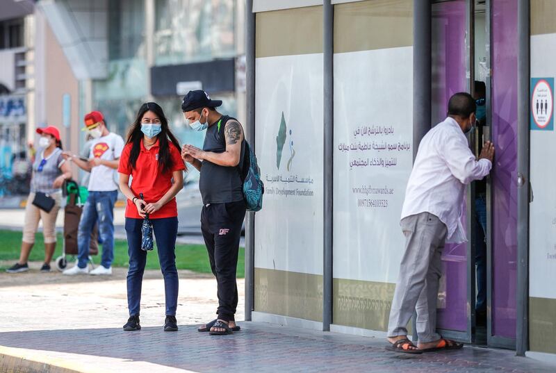 Abu Dhabi, United Arab Emirates, September 18, 2020.  Commuters wait for their bus outside the airconditioned bus stop along al Falah Street in central Abu Dhabi on a Friday afternoon.
Victor Besa /The National
Section:  NA/Standalone.