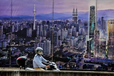 A poster showing Kuala Lumpur's future city skyline in Malaysia. Smart cities offer opportunities for investors. EPA