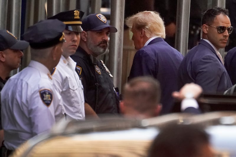 Mr Trump arrives at the Manhattan District Attorney's office. AP