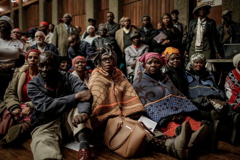 People attend the public land hearings on whether section 25 of the Constitution regarding expropriation of land without compensation should be amended, at the Sedibeng Town Hall in Vereeniging, in Vereeniging, Gauteng province on July 27, 2018. (Photo by GULSHAN KHAN / AFP)