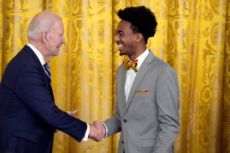 Mr Biden shakes hands with DuWayne. AP