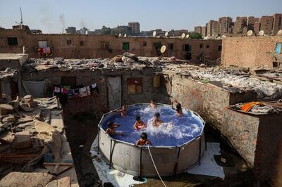 Youths cool off in a swimming pool during high temperatures in Cairo on June 8. Egypt is heating up at one of the world's fastest rates. Bloomberg