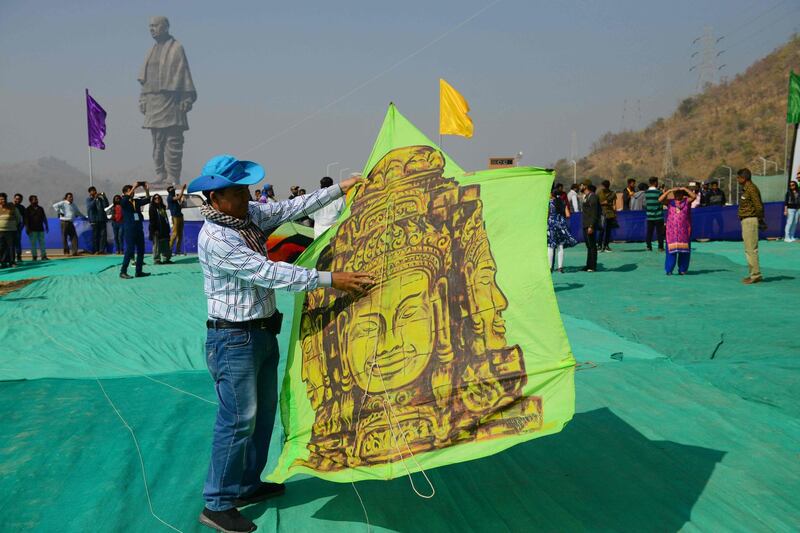 A Cambodian participant prepares to fly a kite decorated with an image of an Angkor Wat monument. AFP