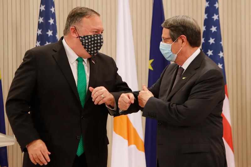 epa08665241 US Secretary of State Mike Pompeo (L) and  Cypriot President Nicos Anastasiades (R) touch elbows after a press conference at the Presidential Palace in Nicosia, Cyprus, 12 September 2020. Pompeo's lightning visit to Cyprus aimed to de-escalate a confrontation between Greece and Turkey over energy reserves in east Mediterranean waters and to affirm Washington's continued engagement in the tumultuous region four days after Russian Foreign Minister Sergey Lavrov pitched Moscow's offer to help ease tensions during his trip to the island nation.  EPA/Petros Karadjias / POOL