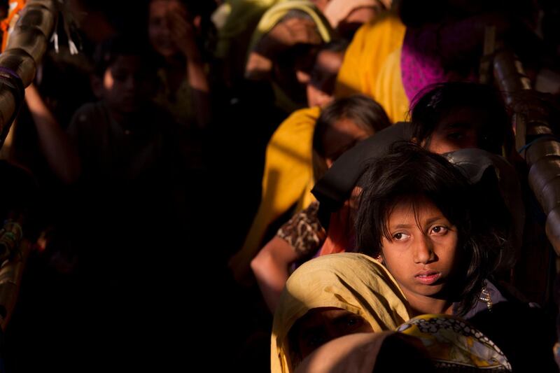 FILE- In this Saturday, Jan. 27, 2018, file photo, Rohingya Muslim women refugees wait in a queue to receive relief material at the Balukhali refugee camp near Cox's Bazar, Bangladesh, Saturday, Jan. 27, 2018. Three female Nobel Peace Laureates are beginning a weeklong trip to Bangladesh to meet Rohingya women who have been tortured, raped and even killed by Myanmar soldiers amid a delayed repatriation process. (AP Photo/Manish Swarup, File)
