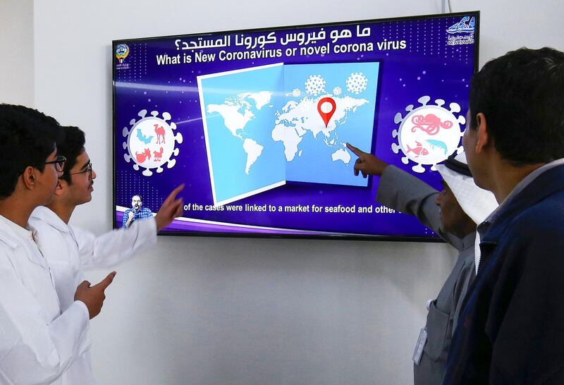 Students watch an instructional video on Coronavirus infection at a school in Kuwait City on February 10, 2020. - More than 28,000 people have now been infected across China as authorities struggle to contain the outbreak despite compelling millions to stay indoors in a growing number of cities. Two dozen countries have confirmed cases of the respiratory disease which emerged from a market selling exotic animals in the central Chinese city of Wuhan late last year. (Photo by YASSER AL-ZAYYAT / AFP)