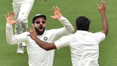 India captain Virat Kohli, left, celebrates with spin bowler Ravichandran Ashwin after beating Australia to win the first Test at Adelaide Oval. AFP