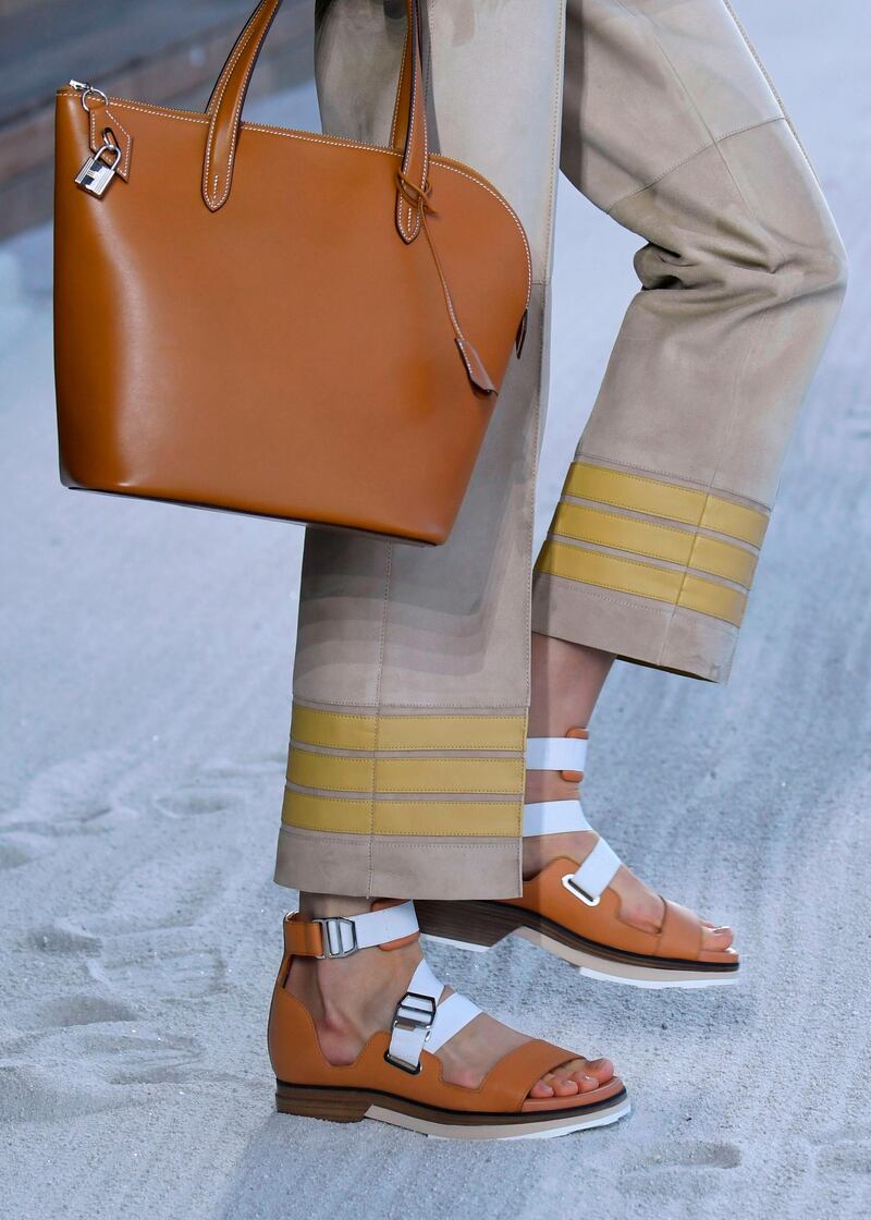 At Hermes, it is always the details that count, and here what might be the season's best flats are teamed with striped hem  trousers, and, of course, a bag. AFP, Bertrand GUAY