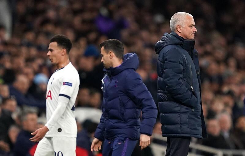 Dele Alli reacts badly to coming off as he passes manager Jose Mourinho. PA