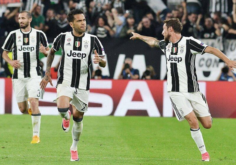 Dani Alves, centre, celebrates after scoring the second Juventus goal in the 2-1 win over Monaco in the Uefa Champions League semi-final second leg on Tuesday. Andrea Di Marco / EPA 