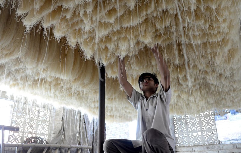 A Pakistani laborer dry vermicelli in Islamabad, Pakistan. EPA