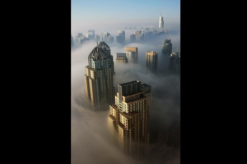 Thick morning fog over Dubai marina this morning, but does it mean winter is finally here? Mark Asquith / The National