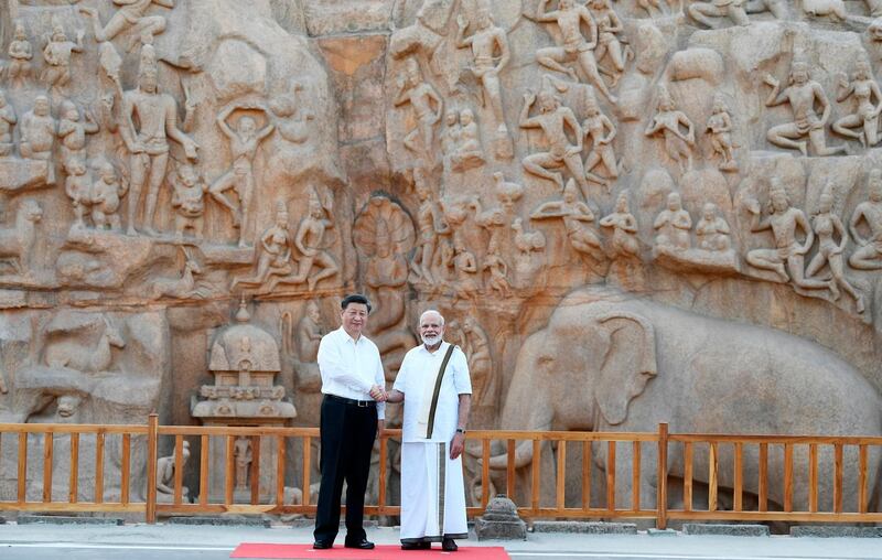 Chinese President Xi Jinping and Indian Prime Minister Narendra Modi shake hands at Arjuna's Penance in Mamallapuram, India. AP
