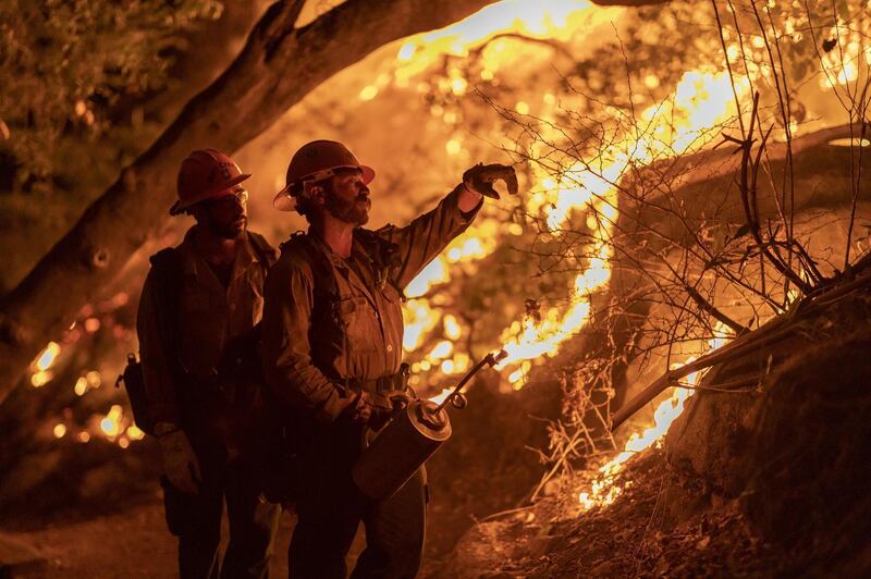 ARCADIA, CA - SEPTEMBER 13: Mill Creek Hotshots set a backfire to protect homes during the Bobcat Fire on September 13, 2020 in Arcadia, California. California wildfires that have already incinerated a record 2.3 million acres this year and are expected to continue till December. The Bobcat Fire, burning in the San Gabriel Mountains, has grown to about 32,000 acres and is only 6% contained.   David McNew/Getty Images/AFP
== FOR NEWSPAPERS, INTERNET, TELCOS & TELEVISION USE ONLY ==
