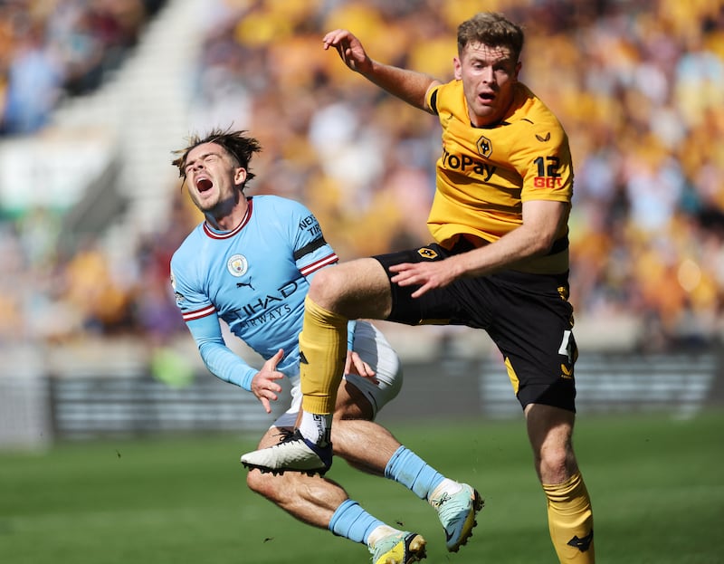 Soccer Football - Premier League - Wolverhampton Wanderers v Manchester City - Molineux Stadium, Wolverhampton, Britain - September 17, 2022 Wolverhampton Wanderers' Nathan Collins fouls Manchester City's Jack Grealish leading to a red card Action Images via Reuters/Carl Recine EDITORIAL USE ONLY.  No use with unauthorized audio, video, data, fixture lists, club/league logos or 'live' services.  Online in-match use limited to 75 images, no video emulation.  No use in betting, games or single club /league/player publications.   Please contact your account representative for further details. 