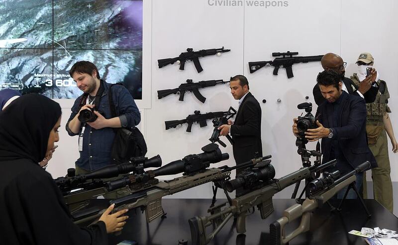 Visitors try out the various firearms at the Kalashnikov stand. Satish Kumar / The National