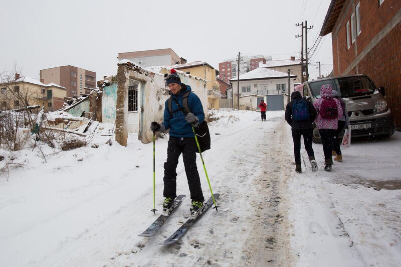 Skiing enthusiasts ski down the snow covered streets of the Kosovo capital Pristina. Visar Kryeziu / AP Photo