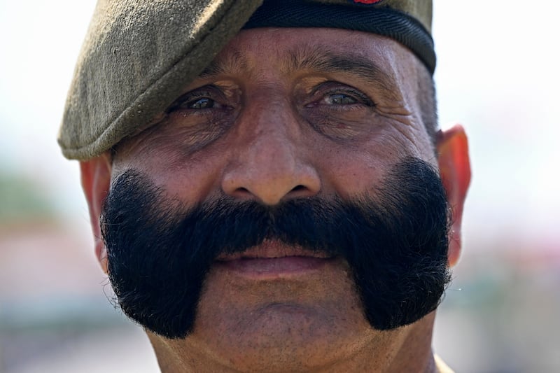 An Indian security guard watches an Independence Day ceremony at Bakshi Stadium in Srinagar. AFP