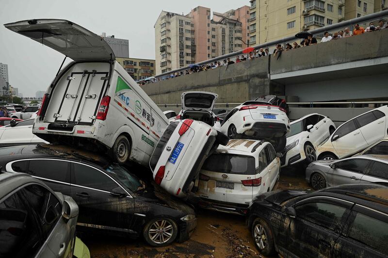 Cars were left in a heap after being swept away.