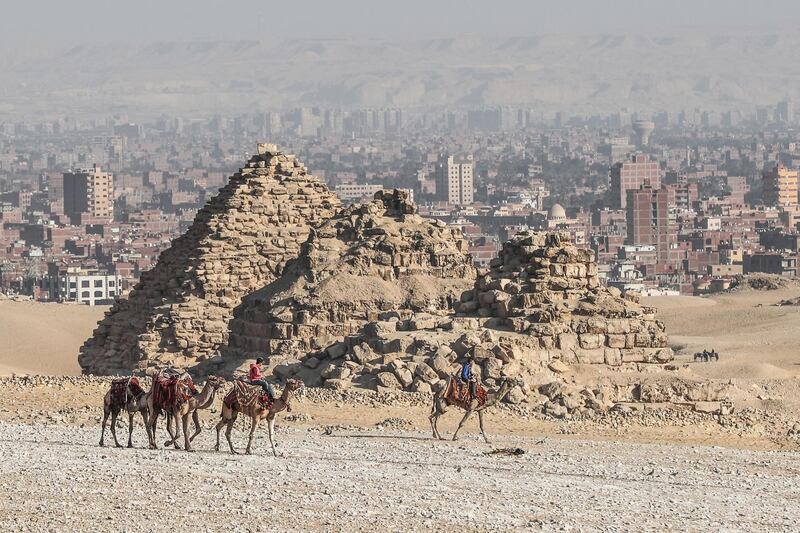 Egyptians ride camels at the Giza pyramids necropolis on the southwestern outskirts of  Cairo. AFP