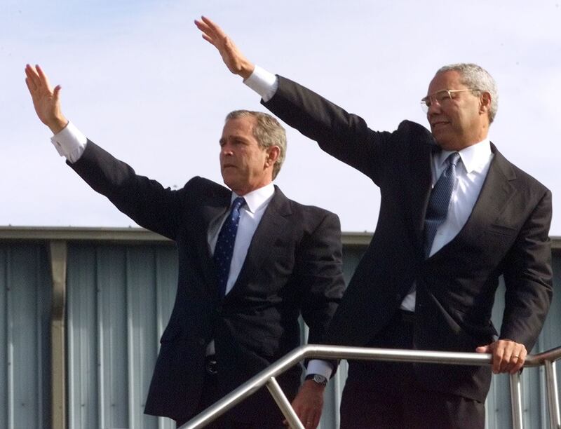 Then-Texas governor and Republican presidential candidate George W. Bush waves with Powell after a rally in Pittsburgh, Pennsylvania, in November 2000. Reuters