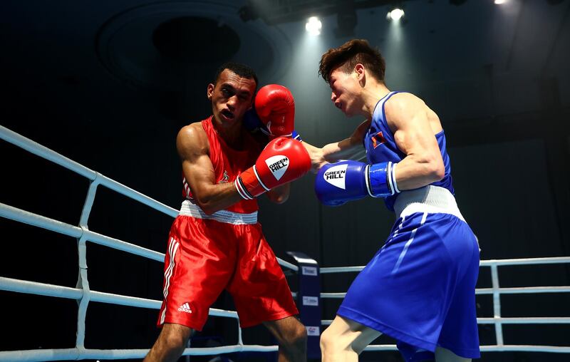 Sultan Al Nuaimi (red) of UAE blocks a right from Kharkuu Enkhmandakh (blue) of Mongolia on a men's flyweight 52kg preliminary bout on day one of the Asian Boxing Championships. Getty Images