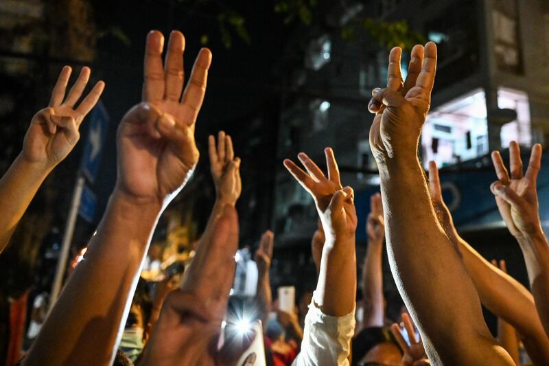 People give a three-finger salute after calls for protest went out on social media in Yangon. AFP