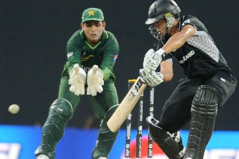 New Zealand batsman Ross Taylor (R) is watched by Pakistan wicketkeeper Kamran Akmal as he plays a shot during the Group A match in the World Cup Cricket tournament between Pakistan and New Zealand at The Pallekele International Cricket Stadium in Pallekele on March 8, 2011. New Zealand scored 302 runs in their alloted 50 overs after winning the toss and electing to bat. AFP PHOTO/Lakruwan WANNIARACHCHI
 *** Local Caption ***  471229-01-08.jpg