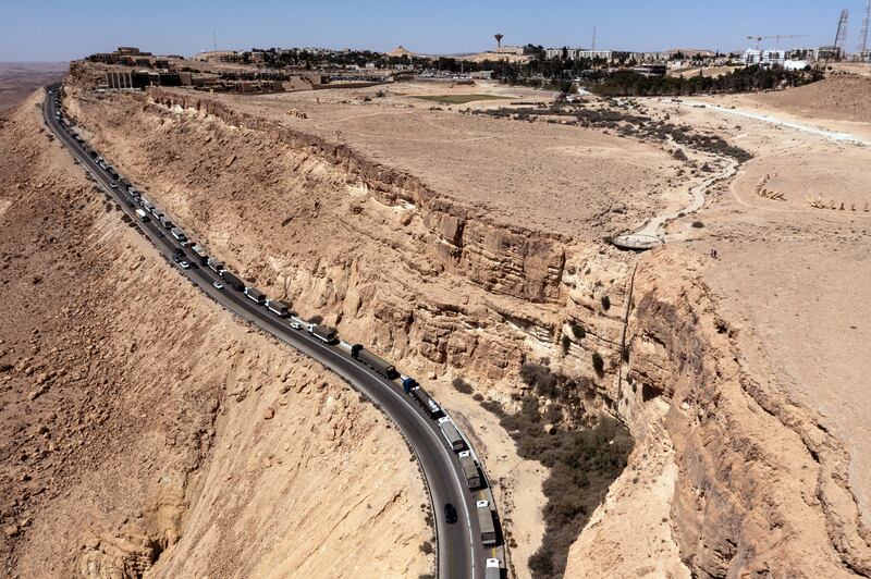 Trucks lined up near Mitzpe Ramon, in southern Israel, after protesters blocked a road to stop humanitarian aid heading to Gaza. Reuters
