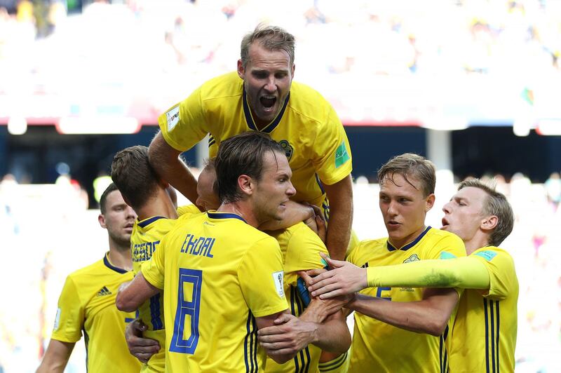 Andreas Granqvist, left, celebrates after Sweden's decisive penalty against South Korea.  Clive Brunskill / Getty Images