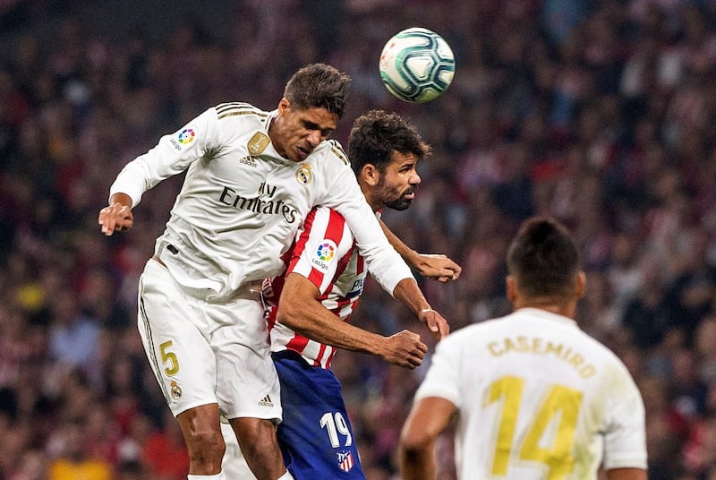 Real Madrid's French defender Raphael Varane beats Atletico Madrid's Diego Costa to the ball. EPA