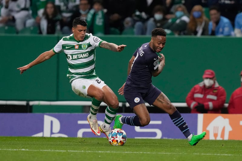 Sporting's Matheus Reis controls the ball as Manchester City's Raheem Sterling chases. AP 