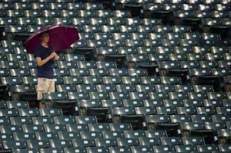 A fan waits out the rain during a delayed start of the game between the Cleveland Indians and the Tampa Bay Rays at Progressive Field on May 31, 2013 in Cleveland.