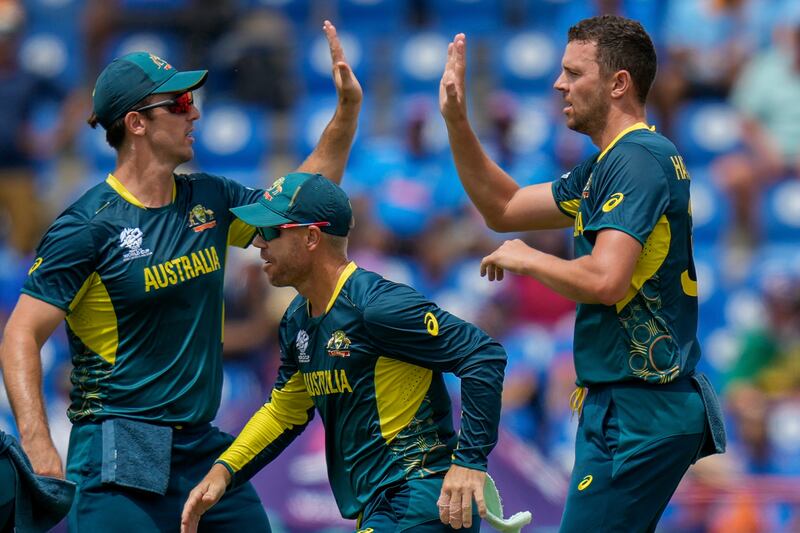 Australia bowler Josh Hazlewood, right, celebrates with captain Mitchell Marsh after the dismissal of India's Virat Kohli. AP