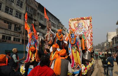 Hindu devotees hold flags reading 'Glory to Lord Rama' at a religious procession in New Delhi on Tuesday before the inauguration of the Ram Temple in Ayodhya. EPA