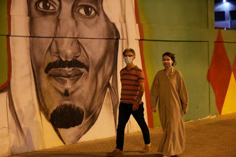 Masked pedestrians in Riyadh during Saudi Arabia's 90th annual National Day celebrations. Reuters