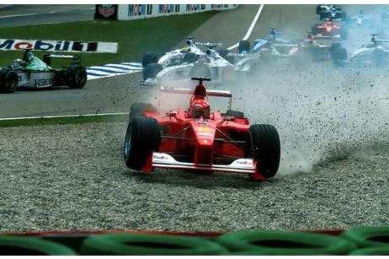 The Ferrari of Michael Schumacher goes skating into the gravel at the first corner of the race.