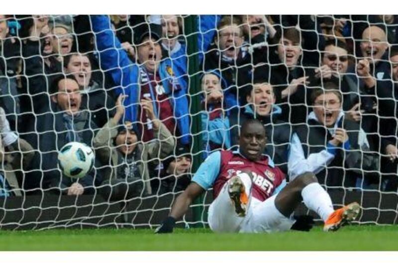 Demba Ba bundles the ball into the Stoke City net for West Ham's first goal in a comfortable 3-0 win at Upton Park yesterday. Ben Stansall / AFP