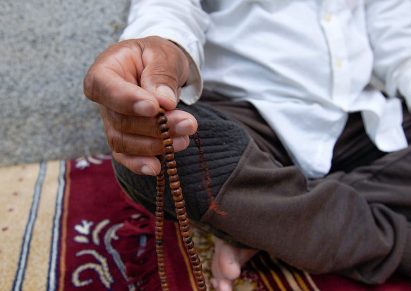 An Al Khayle Mosque worshipper with misbaha prayer beads.