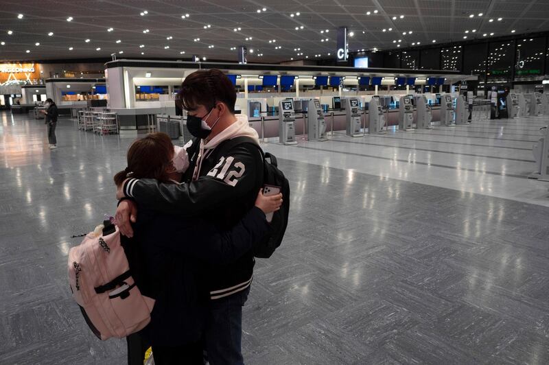 A couple hugs in the empty ticketing area at the Narita International Airport near Tokyo. AP Photo