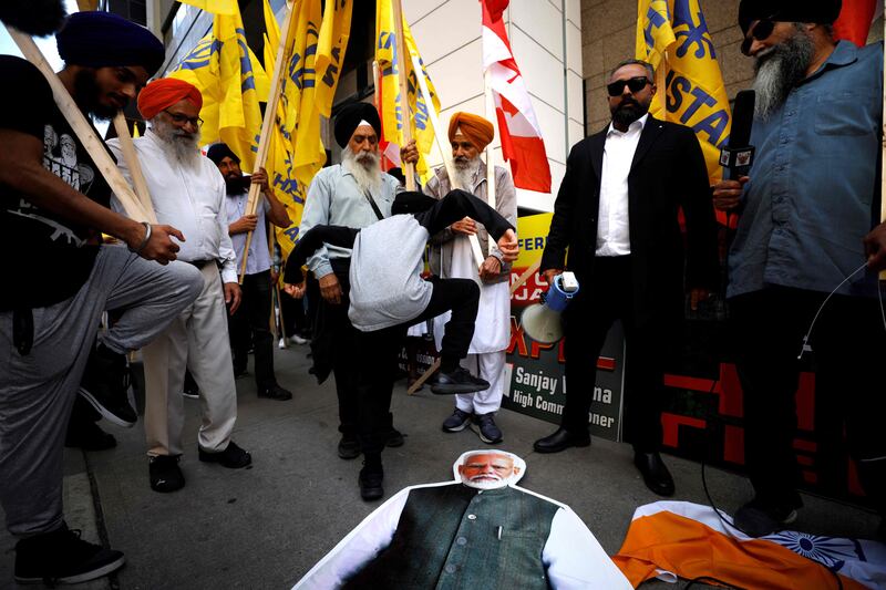 A placard depicting Indian prime minister Narendra Modi is defaced outside the Indian consulate in Toronto. AFP